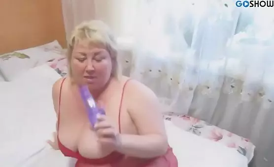 Plump blonde delightedly fucks herself with a dildo