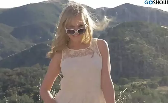 The seductive blonde entices with her charms under the scorching sun